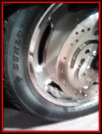 Aluminum motorcycle wheel polished by Fifty Dollar Detail.