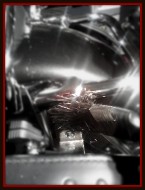 Paint brush cleaning cracks and crevices on a motorcycle by Fifty Dollar Detail.