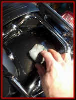 Clay barring a fender on a motorcycle by Fifty Dollar Detail.