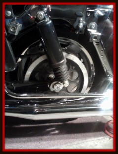 Rear wheel of motorcycle with saddlebag removed for detailing by Fifty Dollar Detail.