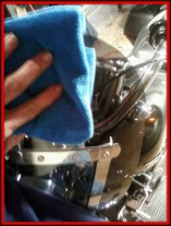 Cleaning motorcycle windscreen with a microfiber towel by Fifty Dollar Detail.