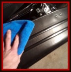 Wiping down motorcycle by Fifty Dollar Detail.