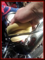 Applying U.V. protectant to a brake cable on a motorcycle by Fifty Dollar Detail.